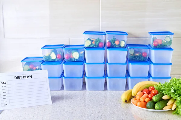 A meal plan for a week on a white table among set of plastic containers for food and food. Proper nutrition during the week.