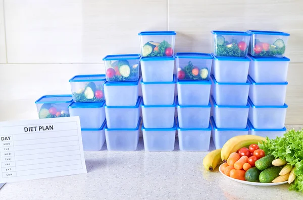 A meal plan for a week on a white table among set of plastic containers for food and food. Proper nutrition during the week.