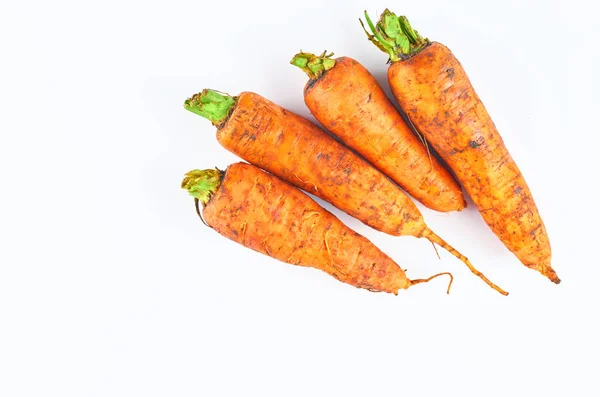 Cuatro zanahorias frescas aisladas sobre fondo blanco. La vista desde arriba. Fondo alimentario ecológico . — Foto de Stock