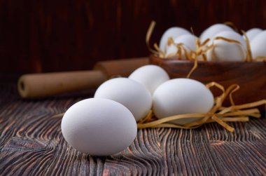 Köy masasında taze beyaz yumurtalar. Düşük anahtar.