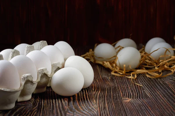 Fresh white eggs on the village table. Low key.