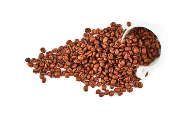 Coffee beans spilled from the mug isolated on a white background.