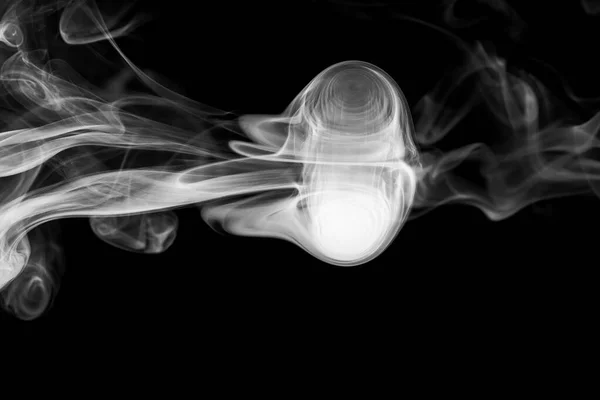 Clouds of white smoke on a black background, movement of smoke on a black background, clouds of smoke in the shape of a jellyfish, smoky background, abstract smoke