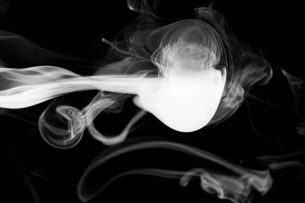 Clouds of white smoke on a black background, movement of smoke on a black background, clouds of smoke in the shape of a jellyfish, smoky background, abstract smoke