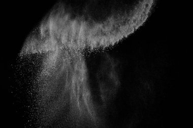 Siyah zemin üzerindeki beyaz parçacıkların hareketlerini dondur. Barut patlaması. Soyut toz tabakası dokusu.