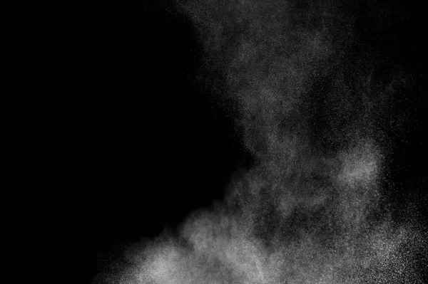 White powder explosion on black background. Abstract white dust texture.