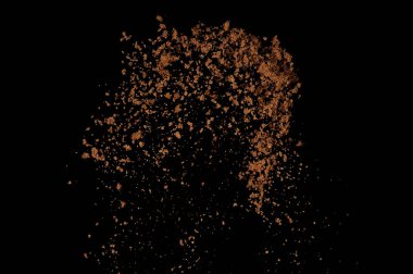 Toprak patlaması siyah arka planda izole edildi. Kahverengi zemin soyut bulutu.