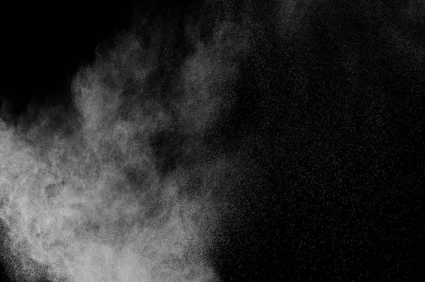 White powder explosion on black background. Abstract white dust texture.