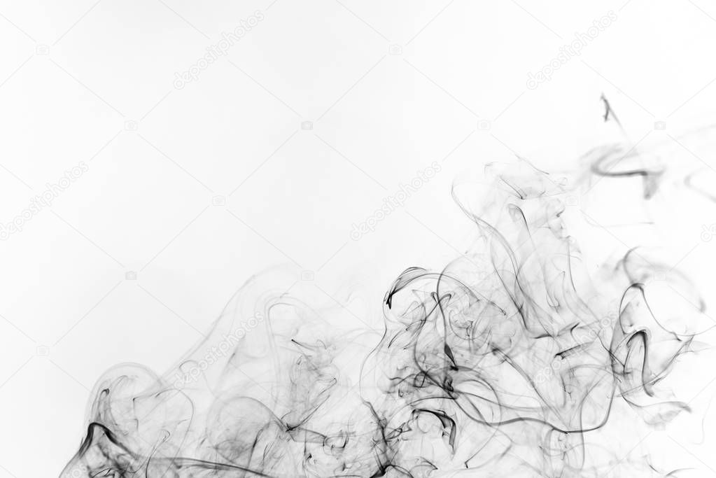 Freeze motion of black smoke isolated on white background. Abstract vape clouds.