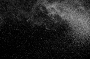 Siyah arka planda soyut su sıçramaları. Beyaz parçacıkların hareketlerini dondur. Yağmur, kar örtüsü dokusu.