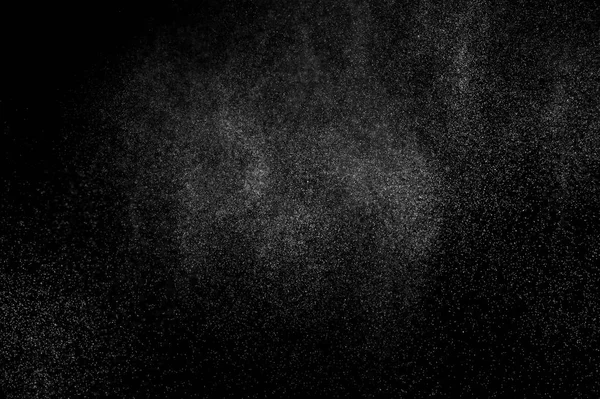 abstract splashes of water on a black background. splashes of milk. abstract spray of water. abstract rain. shower water drops.  white dust explosion. abstract texture. abstract black background.