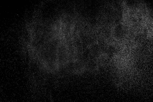 abstract splashes of water on a black background. splashes of milk. abstract spray of water. abstract rain. shower water drops.  white dust explosion. abstract texture. abstract black background.