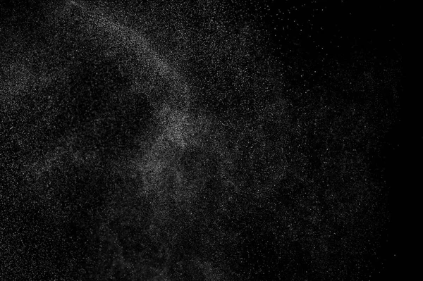 abstract splashes of water on a black background. splashes of milk. abstract spray of water. abstract rain. shower water drops.  white dust explosion. abstract texture. abstract black background.