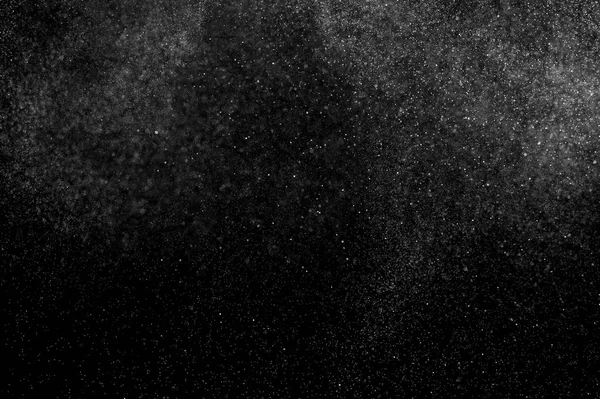abstract splashes of water on a black background. abstract spray of water. abstract rain. shower water drops.  white dust explosion. abstract texture. abstract black background.