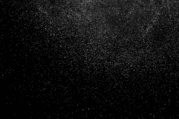 abstract splashes of water on a black background. abstract spray of water. abstract rain. shower water drops.  white dust explosion. abstract texture. abstract black background.