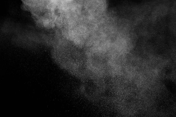 White powder explosion on black background. Abstract white dust texture.