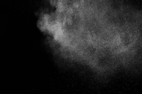 White powder explosion on black background. Abstract white dust texture.