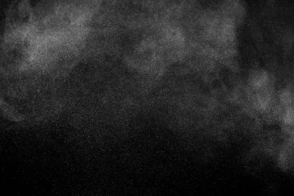 White powder explosion on black background. Abstract white dust texture.