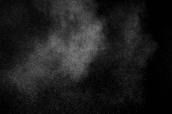 White powder explosion on black background. Abstract white dust texture.