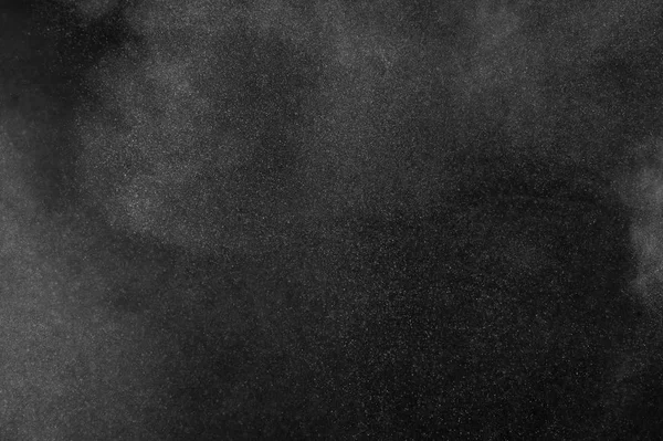 White powder explosion on black background. Abstract  dust texture.