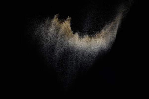 Sandy explosion isolated on black background. Abstract particles cloud. Texture element for design.