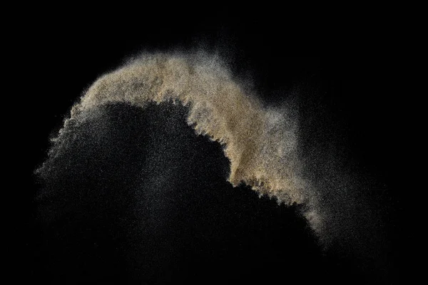 Sandy explosion isolated on black background. Abstract particles cloud. Texture element for design.