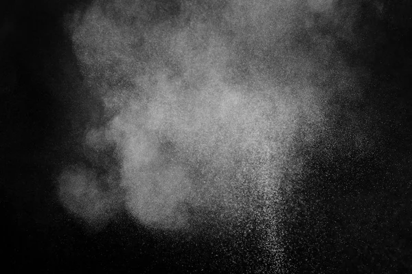 White powder explosion on black background. Abstract  dust texture.