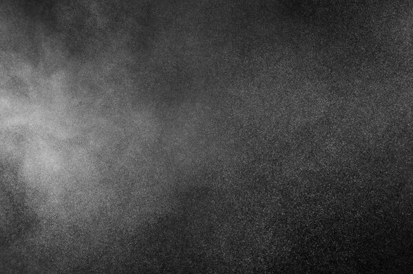White powder explosion on black background. Abstract dust texture.