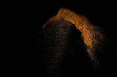 Kumsal patlaması siyah arka planda izole edildi. Soyut kum bulutu.