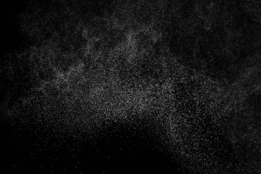 Siyah arka planda soyut su sıçramaları. Beyaz parçacıkların hareketlerini dondur. Yağmur, kar örtüsü dokusu.