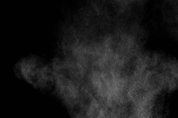 White powder explosion on black background. Abstract white dust texture.