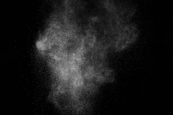 Siyah zemin üzerindeki beyaz parçacıkların hareketlerini dondur. Barut patlaması. Soyut toz tabakası dokusu.