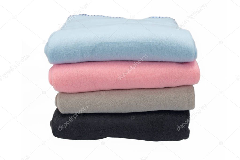 Fleece bedspreads. Four colors. Stack of covers. Isolated image on white background.