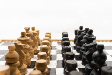 ahşaptan yapılmış siyah ve beyaz satranç taşlarının iki tarafı birbirine dönüktür. Gönderileri yerleştirmek için beyaz bir arka plan vardır