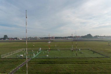 Badung/Bali-07 Aralık 2017: Ngurah Rai Airport Bali'de sabah saatlerinde gökyüzünün tam gri cirrus bulutları olduğu meteorolojik bahçe manzarası