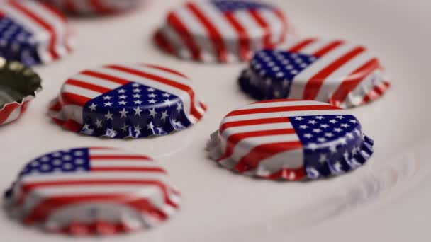 Rotating shot of bottle caps with the American flag printed on them — Stock Video