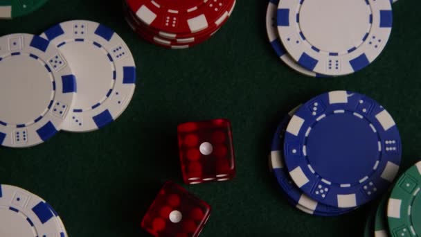 Rotating shot of poker cards and poker chips on a green felt surface — Stock Video