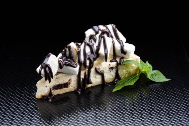 Cheesecake with chocolate and marshmallow. On a black background