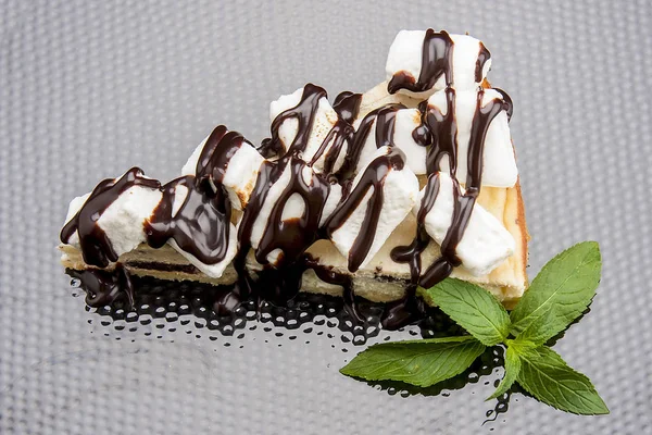 Cheesecake with chocolate and marshmallow. On a black background