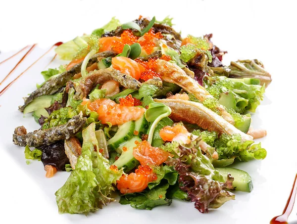 Salad with salmon belly and tobiko caviar on white background — Stock Photo, Image