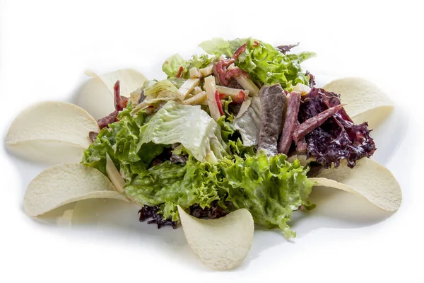 Salad with tongue and greens with chips on white background — Stock Photo, Image