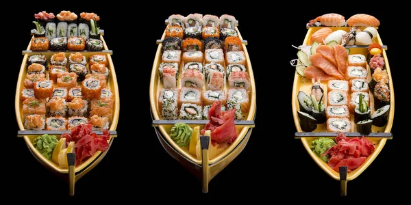 Sushi szett egy fából készült hajón fekete alapon — Stock Fotó