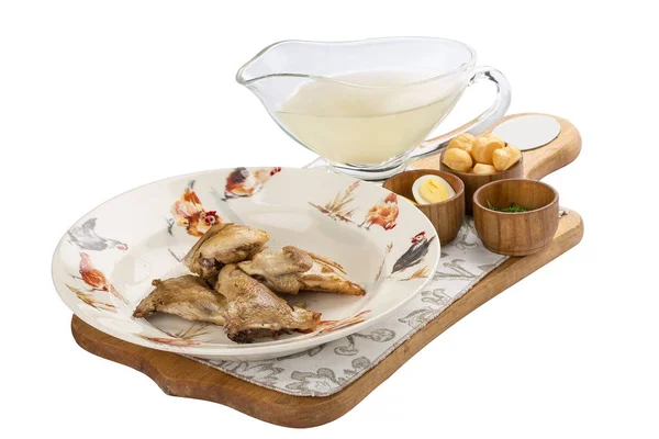 Quail broth with crackers and herbs on a wooden board. On white background. — Stock Photo, Image