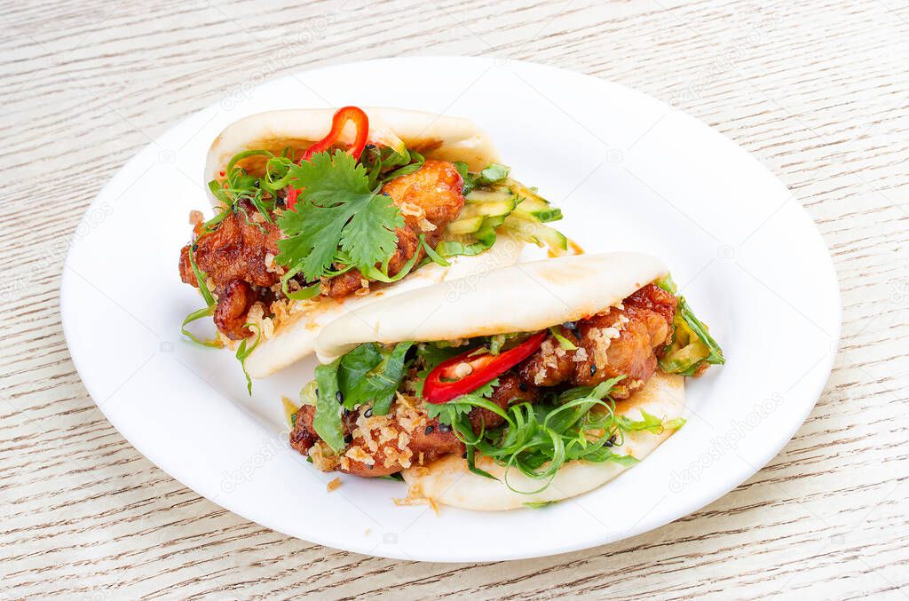 Bao. Rice steamed buns with chicken, spicy herbs and chili peppers. Pan-Asian dish.