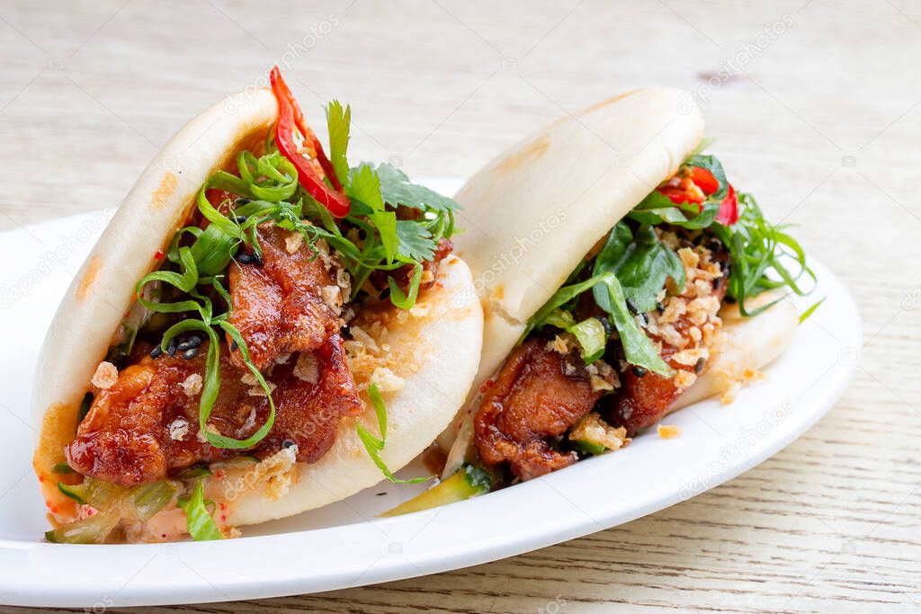 Bao. Rice steamed buns with chicken, spicy herbs and chili peppers. Pan-Asian dish.