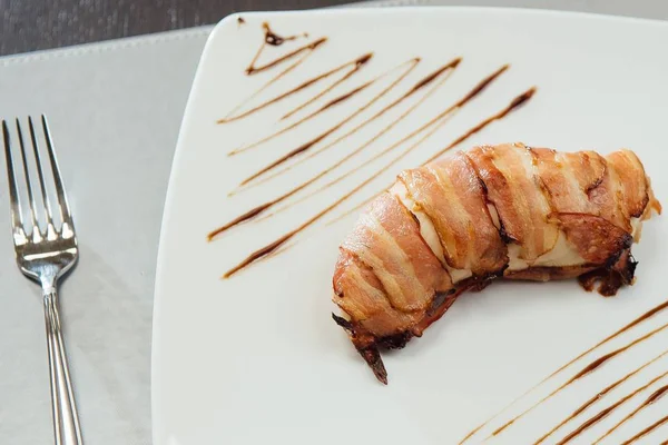 Masada beyaz bir plaka üzerinde kızarmış pastırma ile et