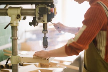 Master marangoz atölye sondaj için makine üzerinde çalışır