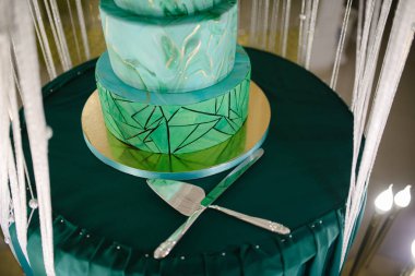 Düğün masasında büyük yeşil düğün pastası yakın çekim