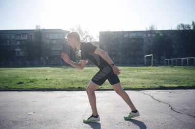 Stadyumda Atlet koşu için başlangıç pistinde duruyor