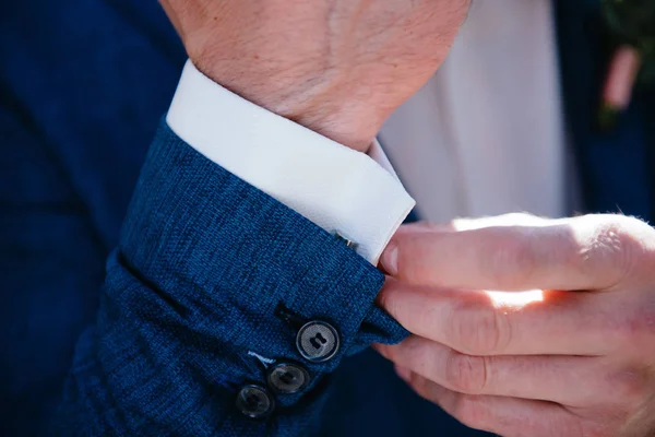 Man in suit with hand adjusts sleeve of shirt close-up — Stock Photo, Image